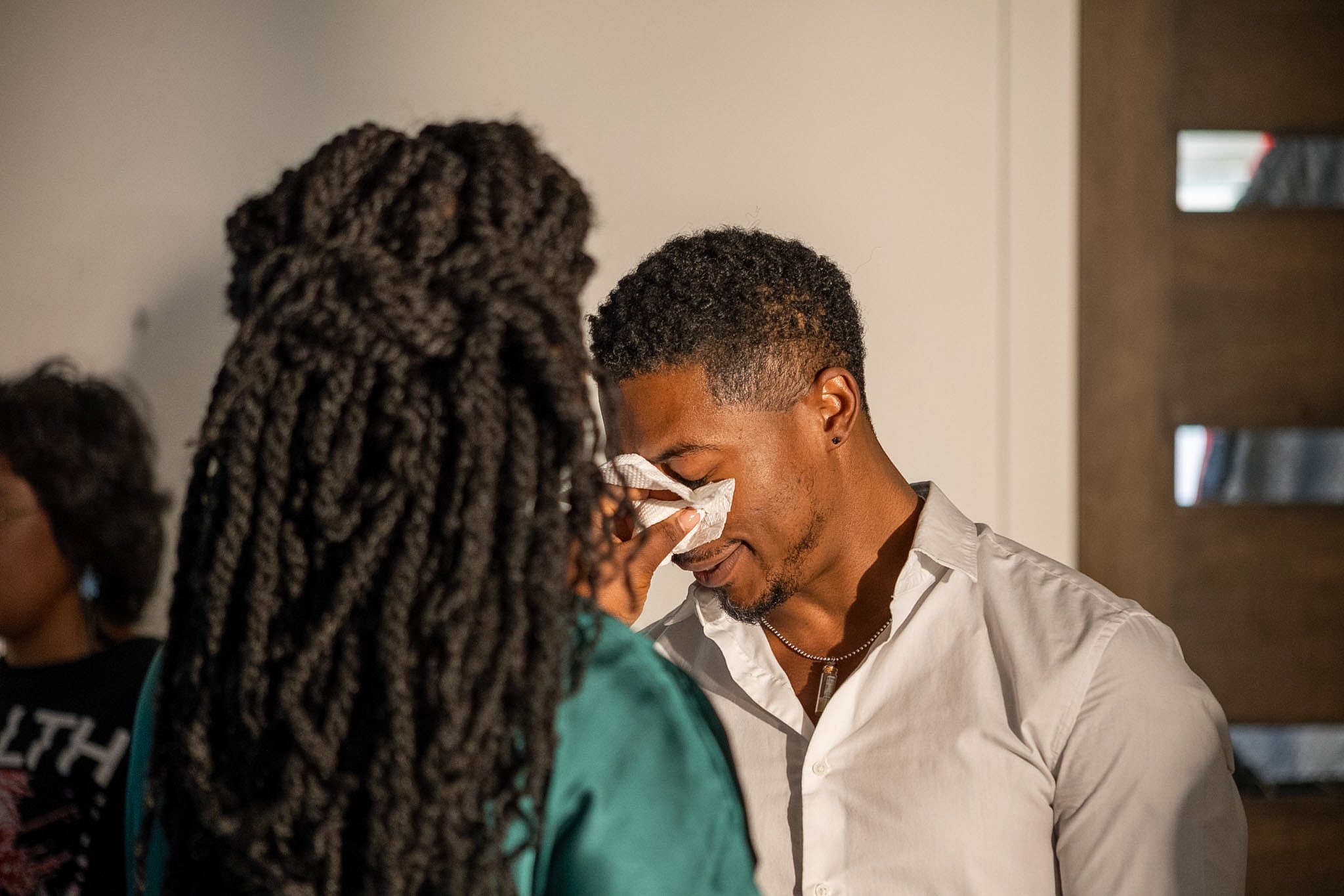 Emotional moment on the Between Two Lives set as an actor is comforted